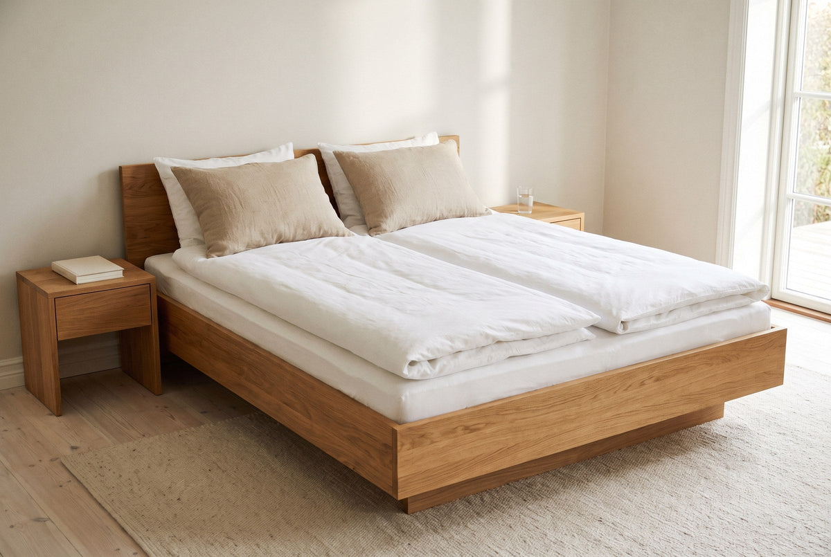 A bright bedroom with one bed made up with two separate duvets
