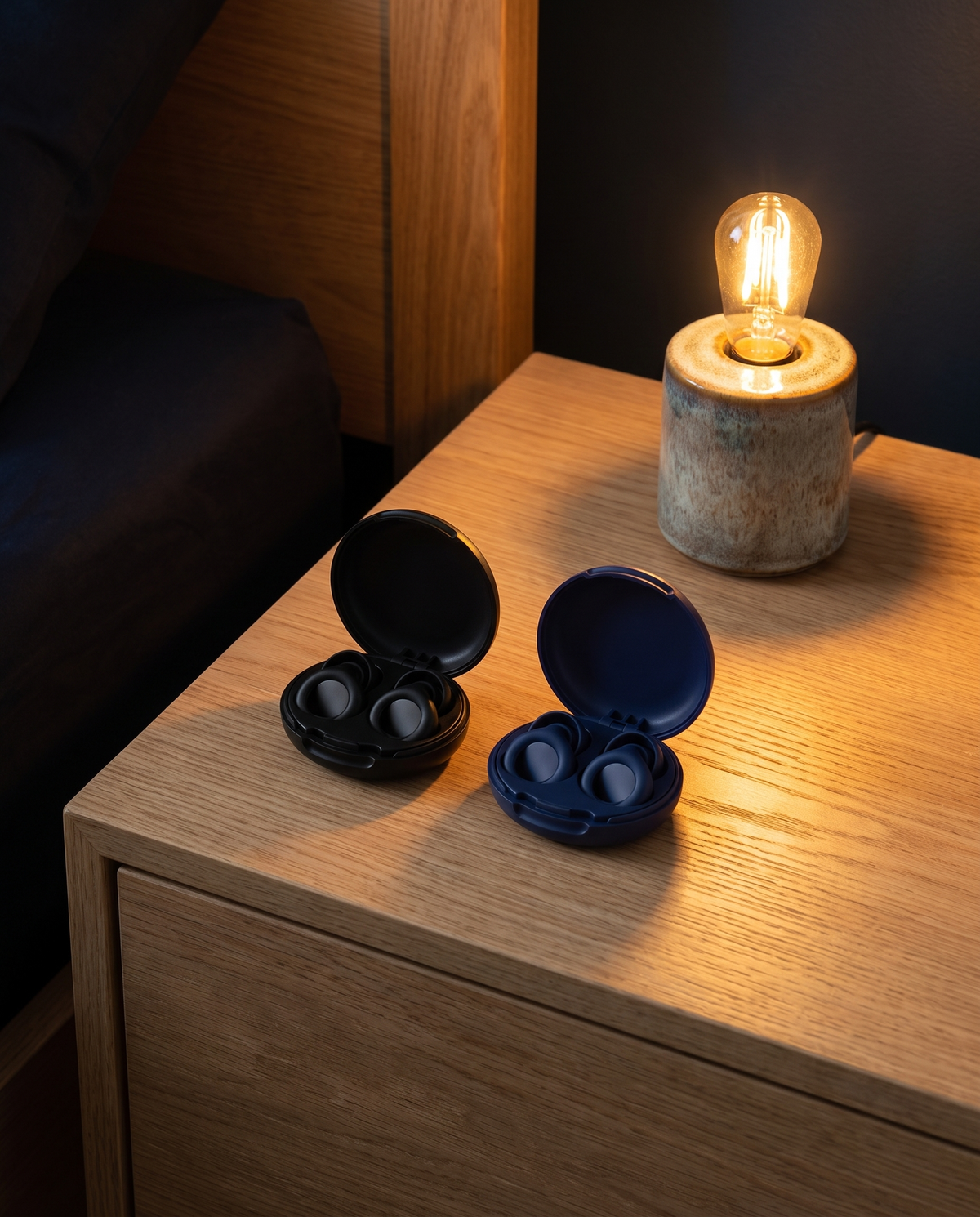 Two Vespré Deep cases open on a nightstand, black and navy