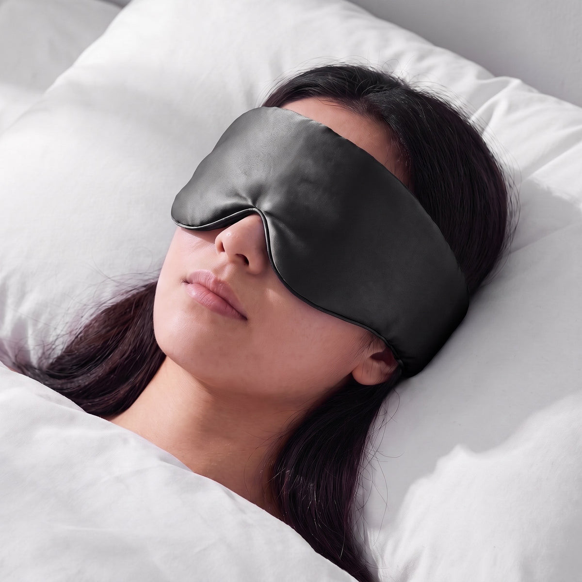A woman asleep wearing the Vespré Silk Sleep Mask