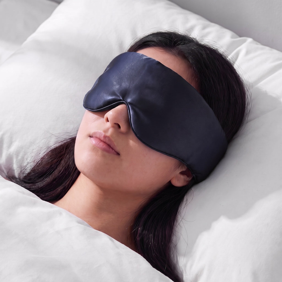 A woman asleep wearing the Vespré Silk Sleep Mask