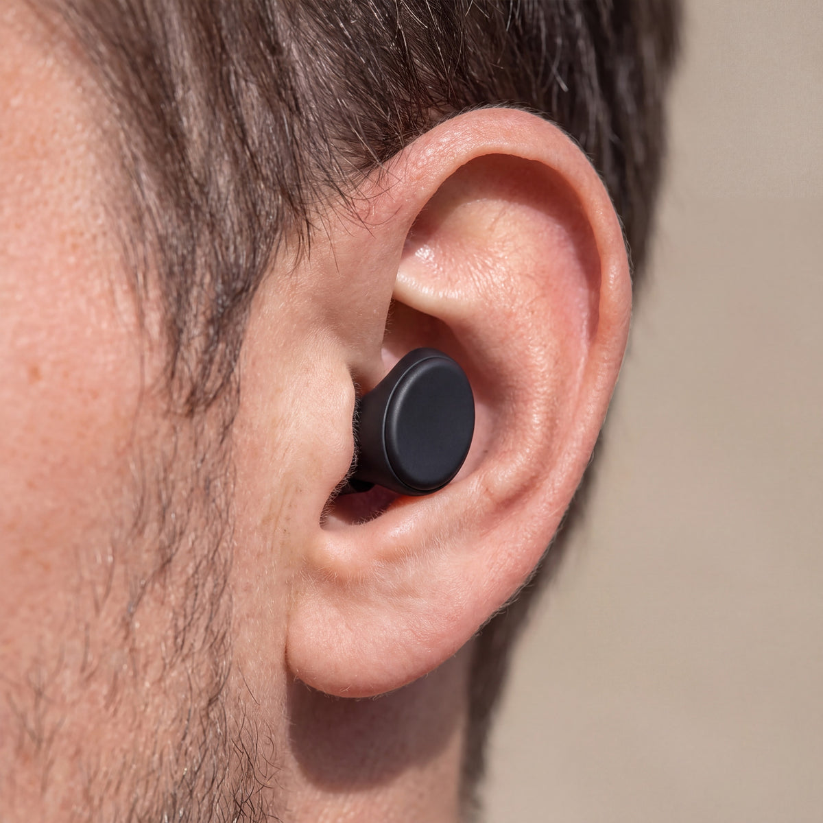 A Vespré Rest earplug sitting inside the ear, low and almost flush