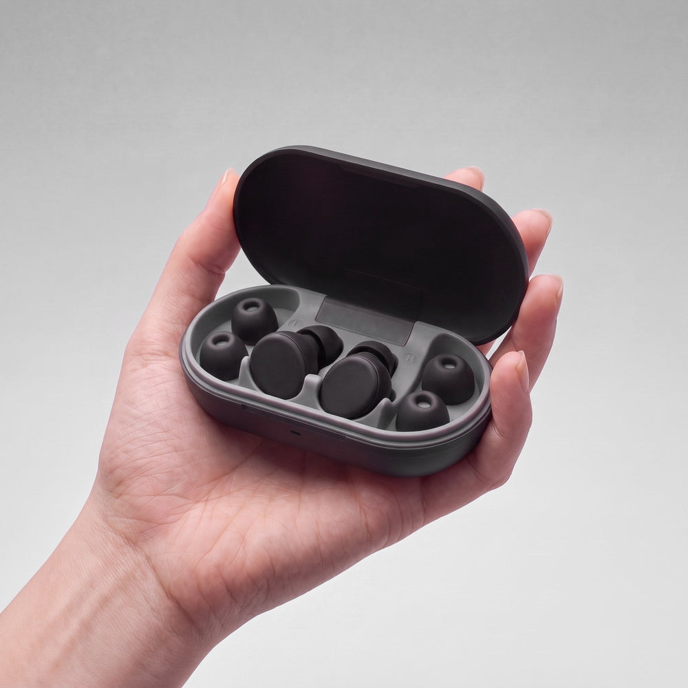 Vespré Rest in Matte Black, open case held in a hand for scale