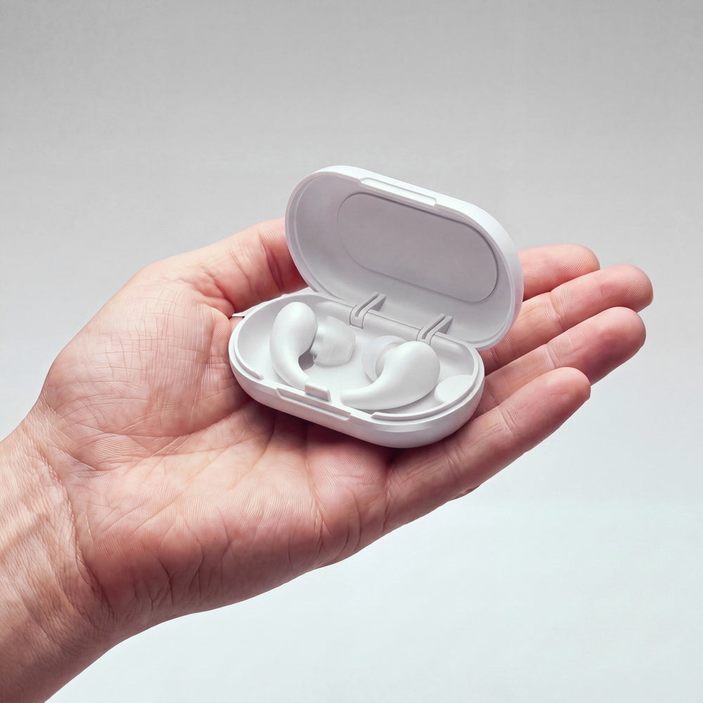 Vespré Wing in Cloud, open case with both earplugs held in a hand for scale