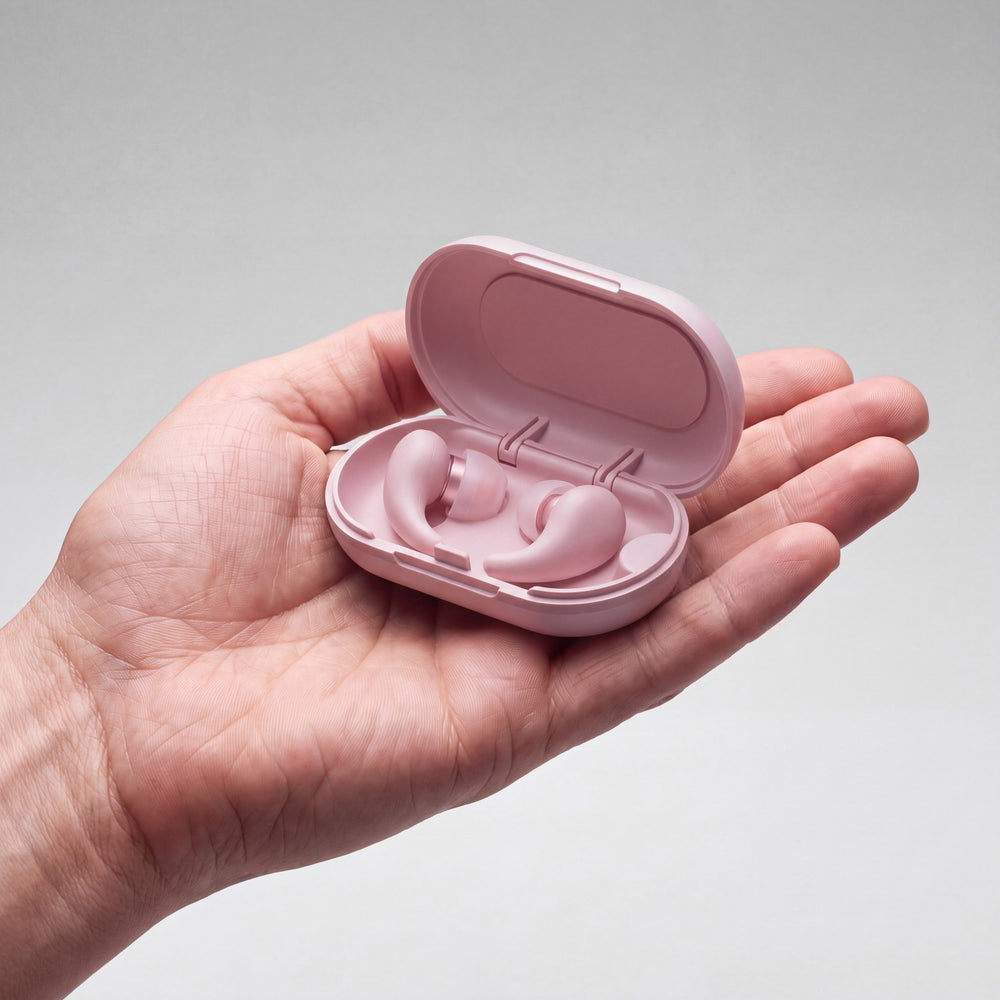 Vespré Wing in Rose, open case with both earplugs held in a hand for scale